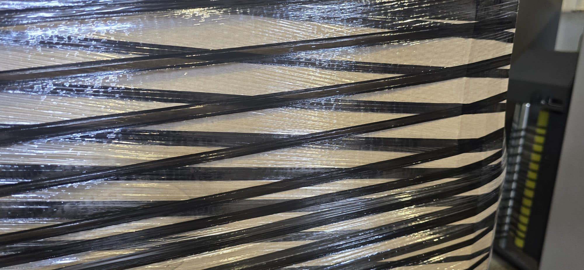 Reinforced stretch film wrapped around a loaded pallet